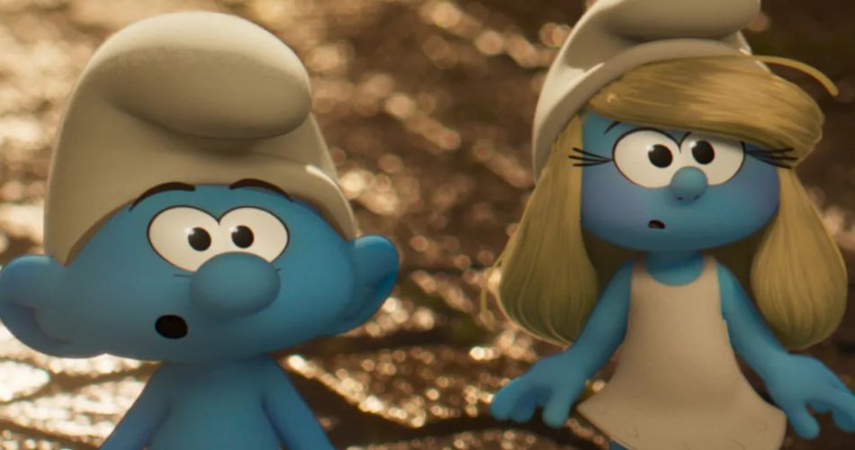 A close-up, 3D animated image featuring two iconic Smurf characters against a blurred, warmly lit, earthy background. On the left is a classic blue Smurf with a white hat, looking slightly confused with wide eyes and a small "o" shaped mouth. On the right stands Smurfette, recognizable by her blonde hair and white dress, looking toward the left with a similarly curious expression. The image represents the charming characters players encounter in a Smurfs cooking game.