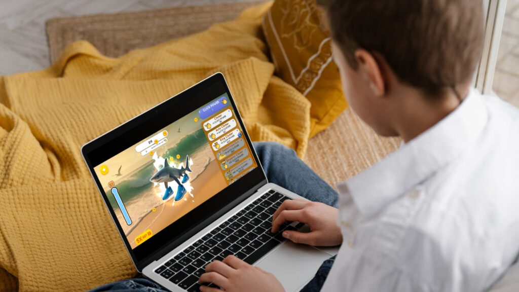 Teenagers playing Italian Brainrot Clicker on a laptop, featuring a surreal shark with sneakers, highlighting the meme-driven casual gaming trend